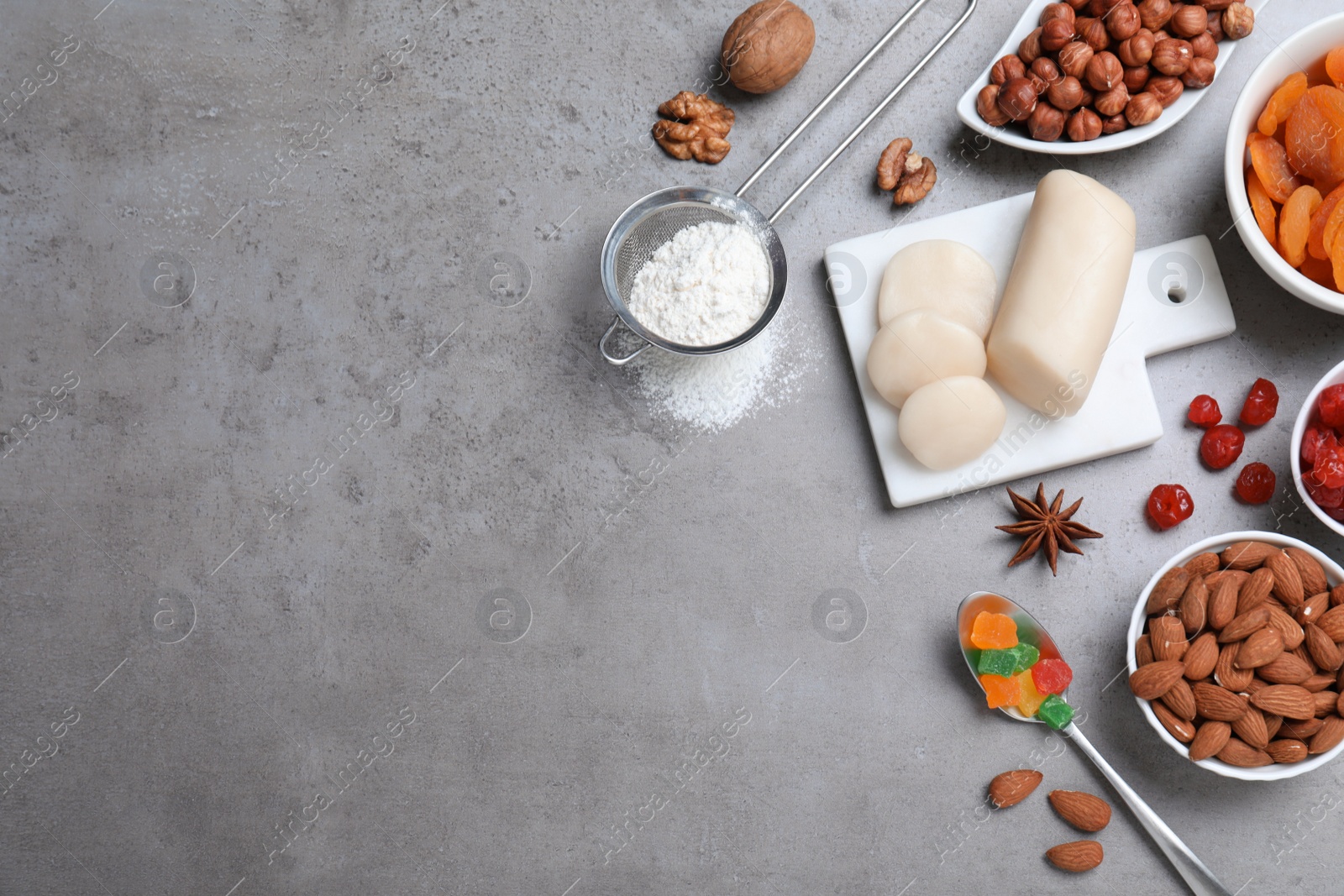 Photo of Ingredients for homemade Stollen on grey table, flat lay. Baking traditional German Christmas bread