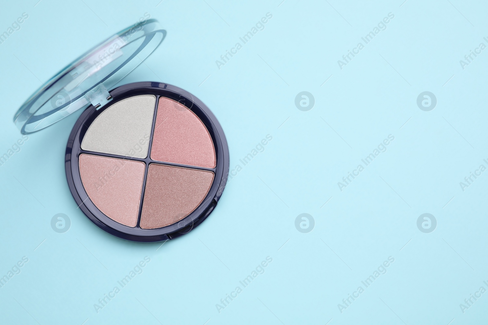 Photo of Colorful contouring palette on light blue background, top view with space for text. Professional cosmetic product