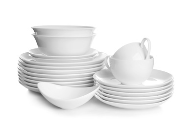 Stacks of ceramic dishware on white background