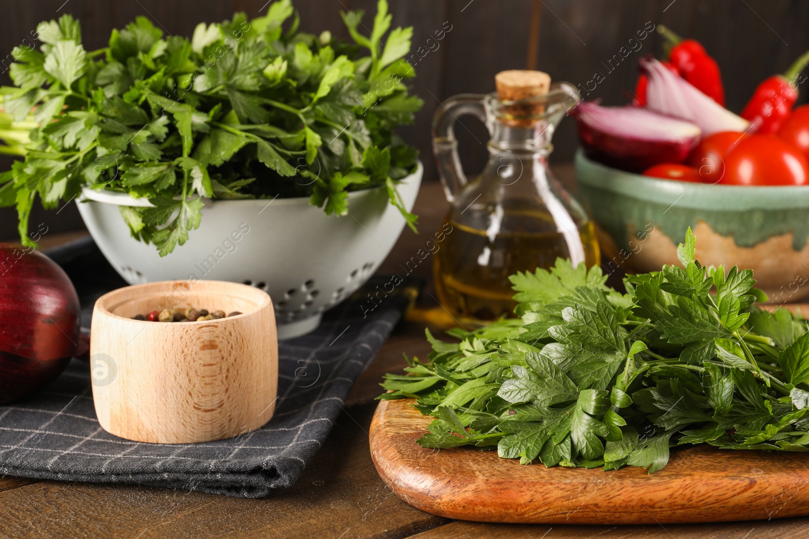 Photo of Fresh green parsley and different products on wooden table, closeup