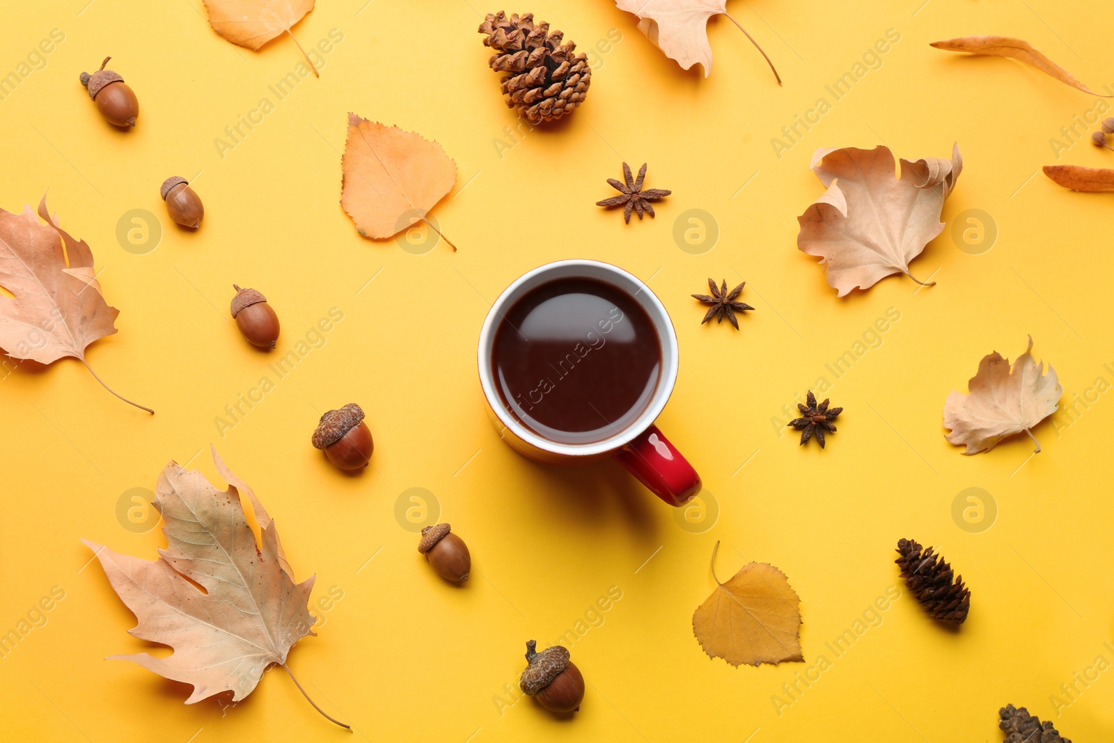 Photo of Flat lay composition with hot drink on yellow background. Cozy autumn