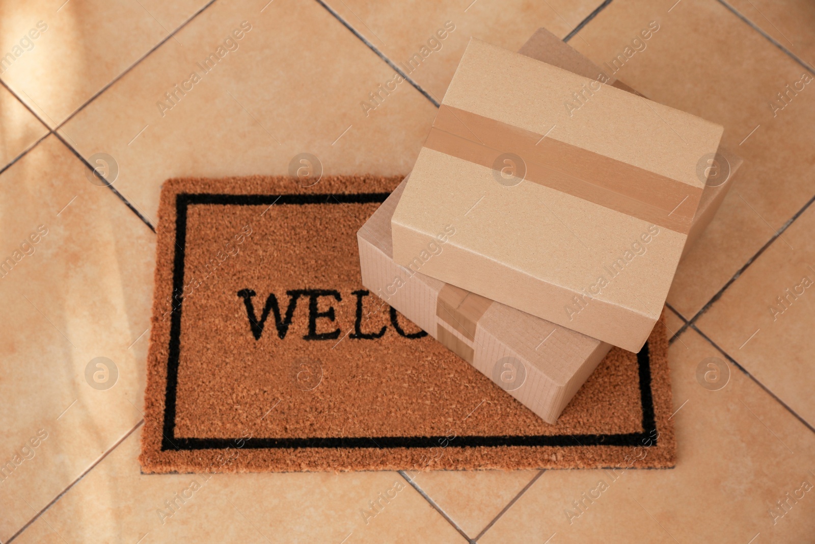 Photo of Stack of parcels on door mat, above view