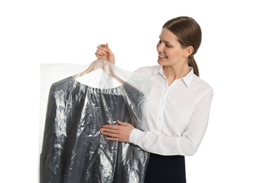 Young woman holding hanger with dress in plastic bag on white background. Dry-cleaning service