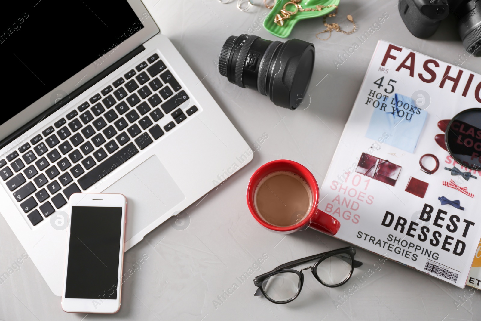 Photo of Blogger work space with cup of coffee and laptop on table, flat lay