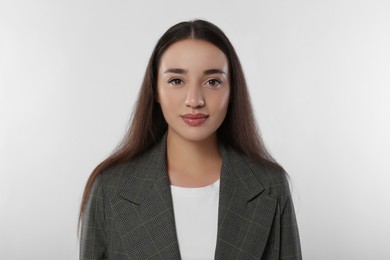 Photo of Portrait of beautiful young woman in stylish jacket on white background