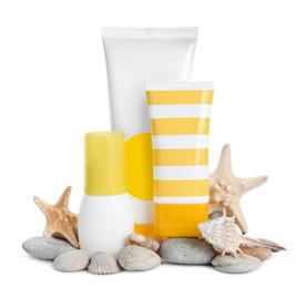 Photo of Different suntan products, seashells, starfishes and stones on white background