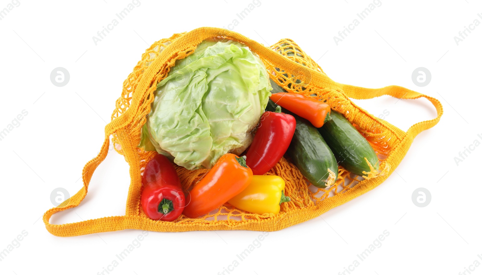 Photo of String bag with different vegetables isolated on white