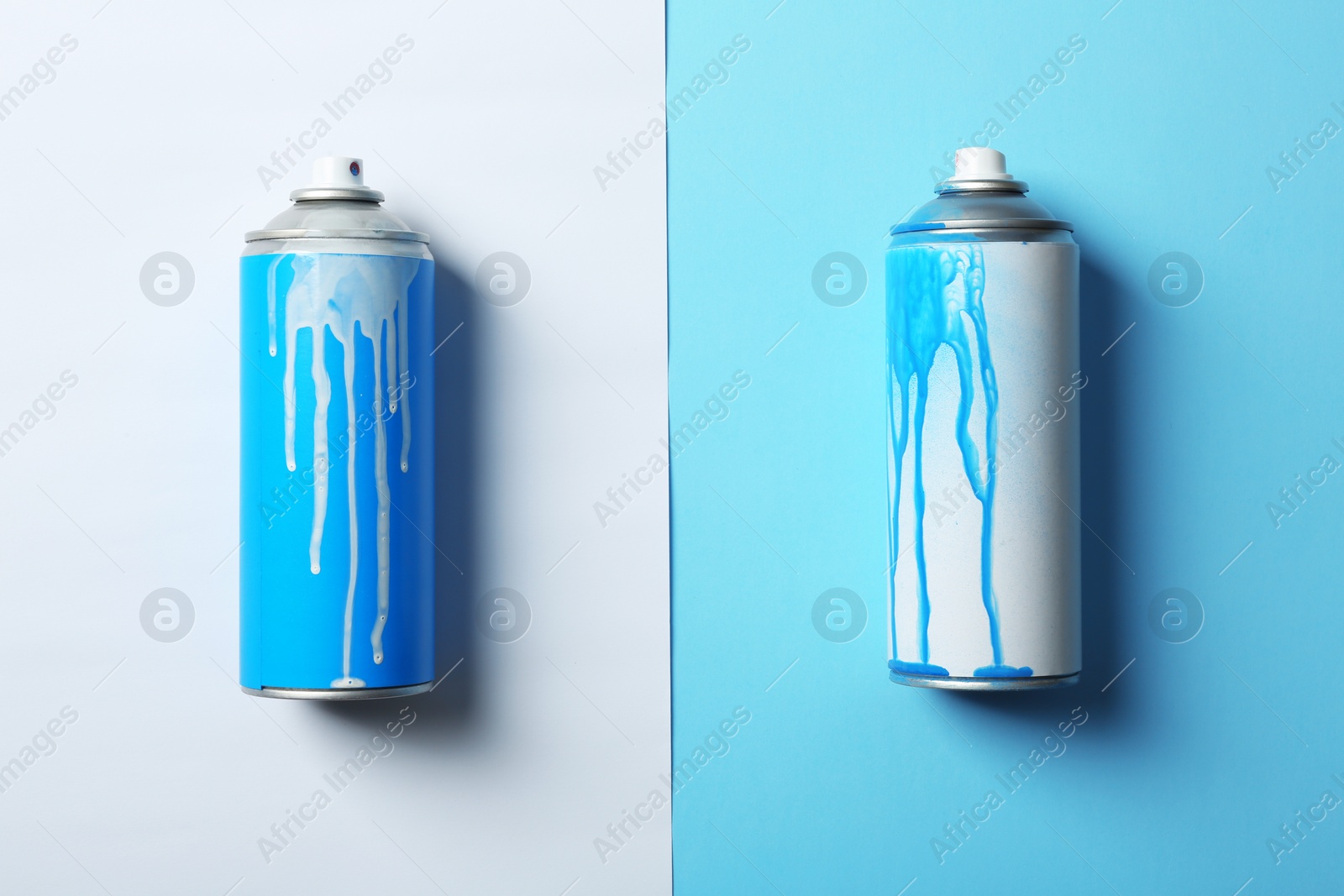 Photo of Used cans of spray paint on color background, flat lay