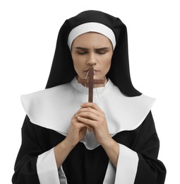 Nun holding wooden cross and praying to God on white background