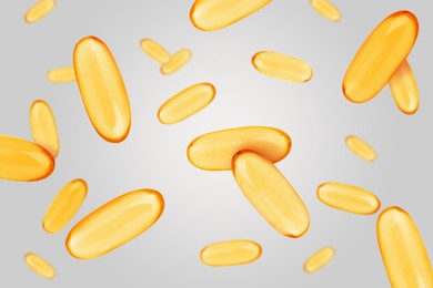 Image of Vitamin. Softgel capsules falling on light grey background