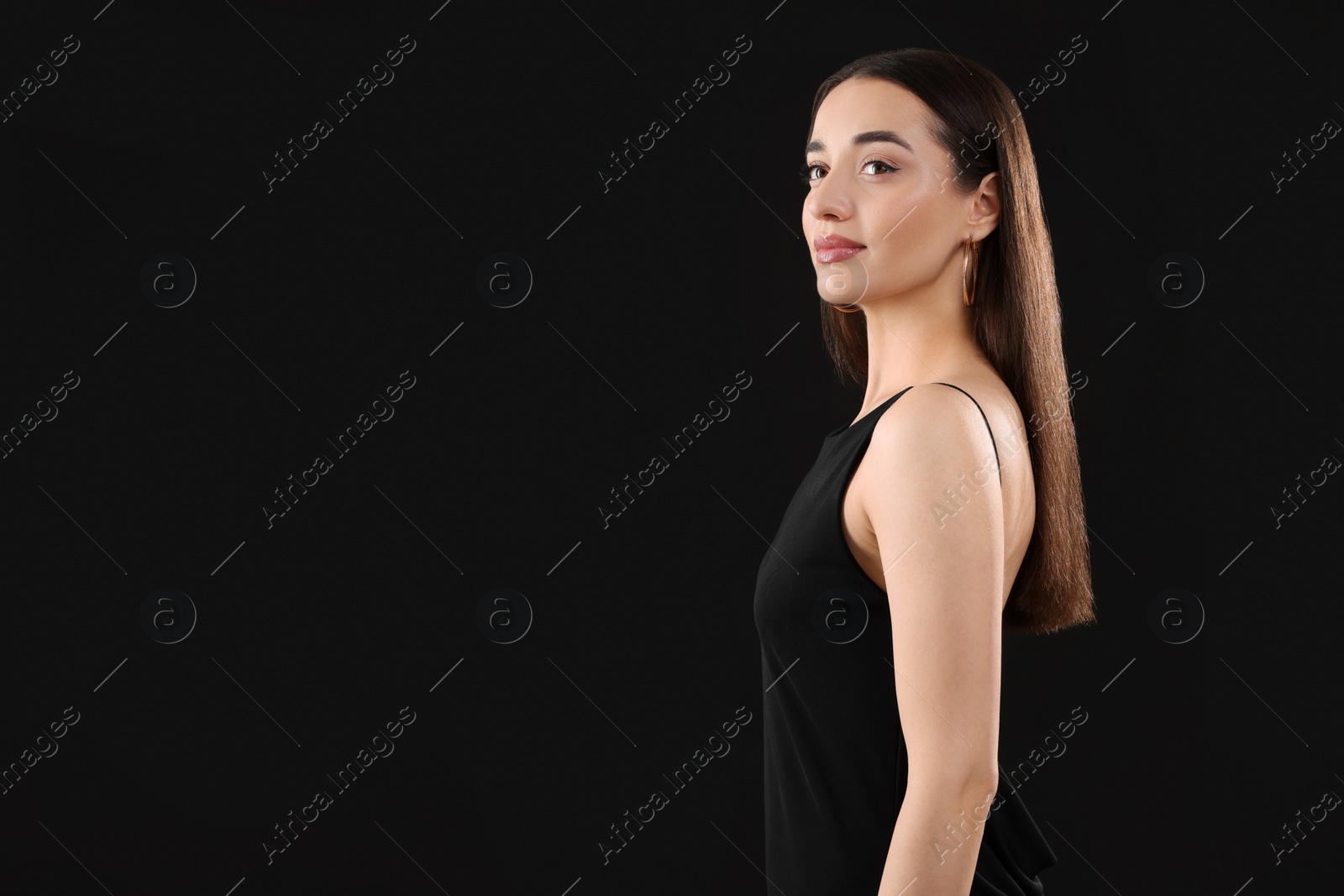 Photo of Beautiful young woman on black background, space for text