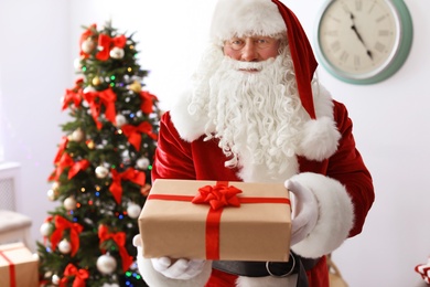 Photo of Authentic Santa Claus with gift box indoors