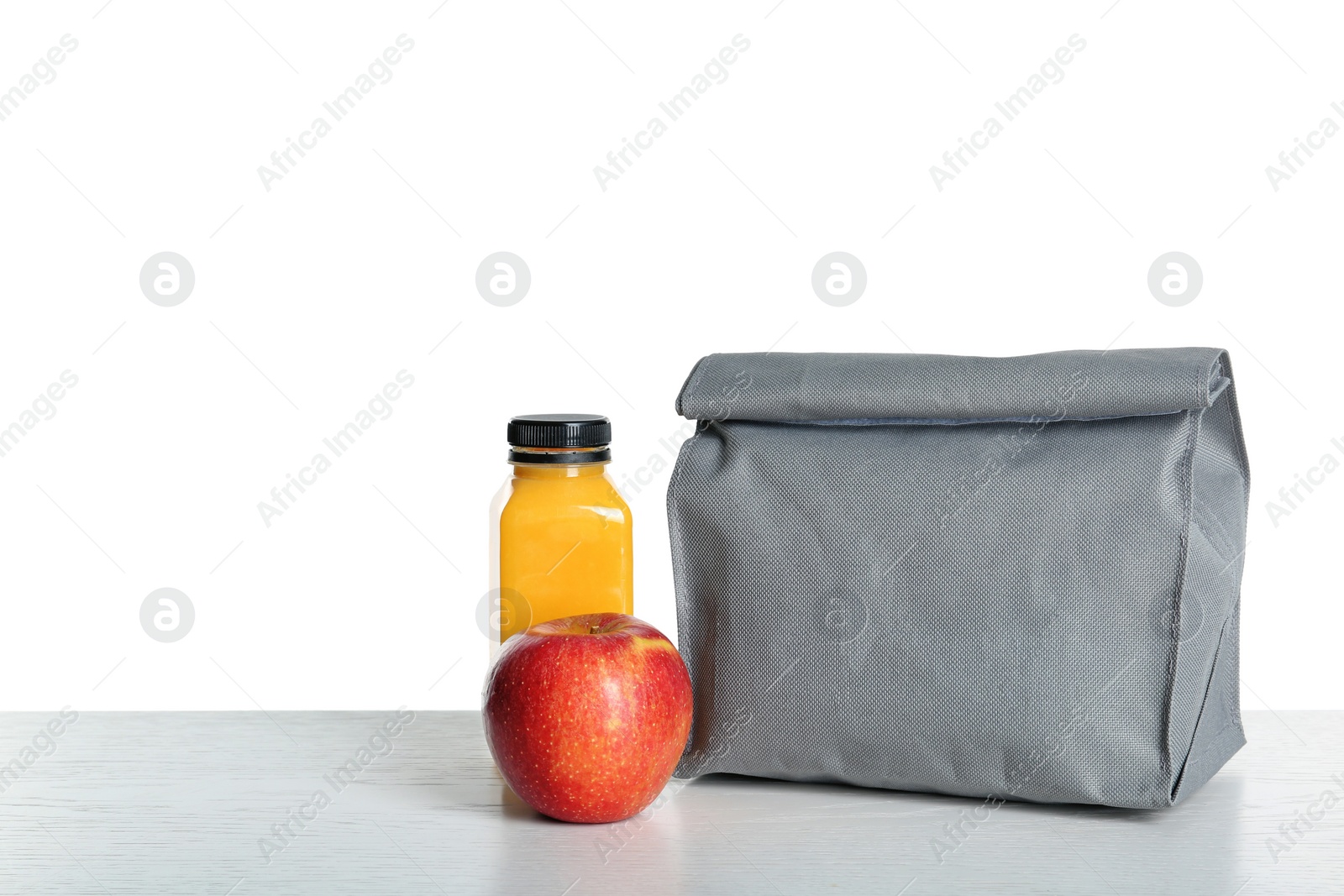 Photo of Healthy food and bag on table against white background. School lunch