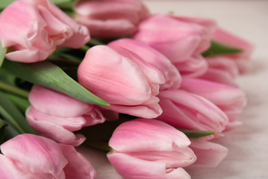 Beautiful pink spring tulips on white wooden background, closeup