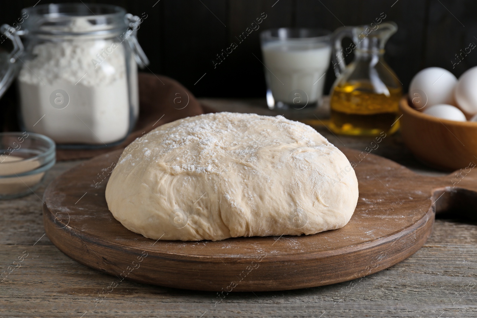 Photo of Fresh yeast dough and ingredients on wooden table