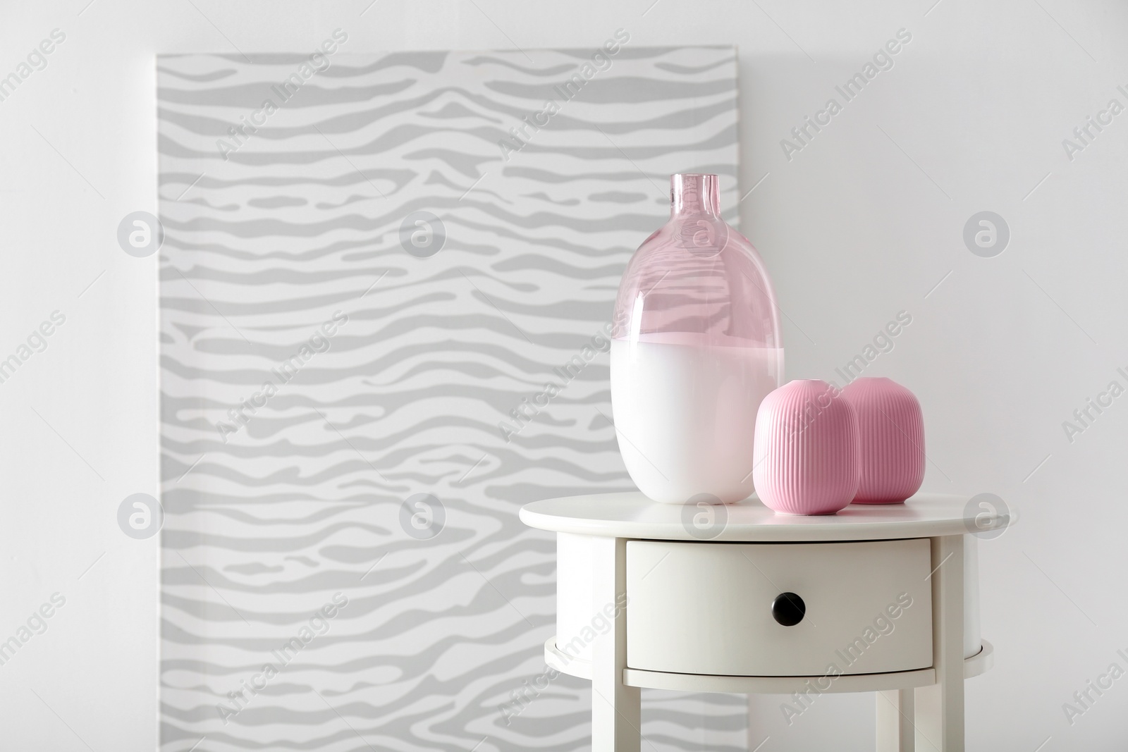 Photo of Living room interior with vases and table near white wall. Space for text