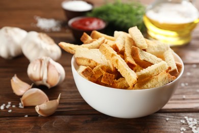 Photo of Delicious hard chucks and garlic on wooden table