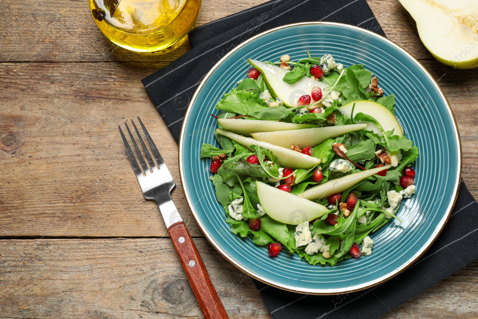 Photo of Fresh salad with pear served on wooden table, flat lay