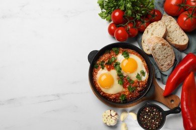 Photo of Flat lay composition with delicious shakshuka in frying pan on white marble table. Space for text