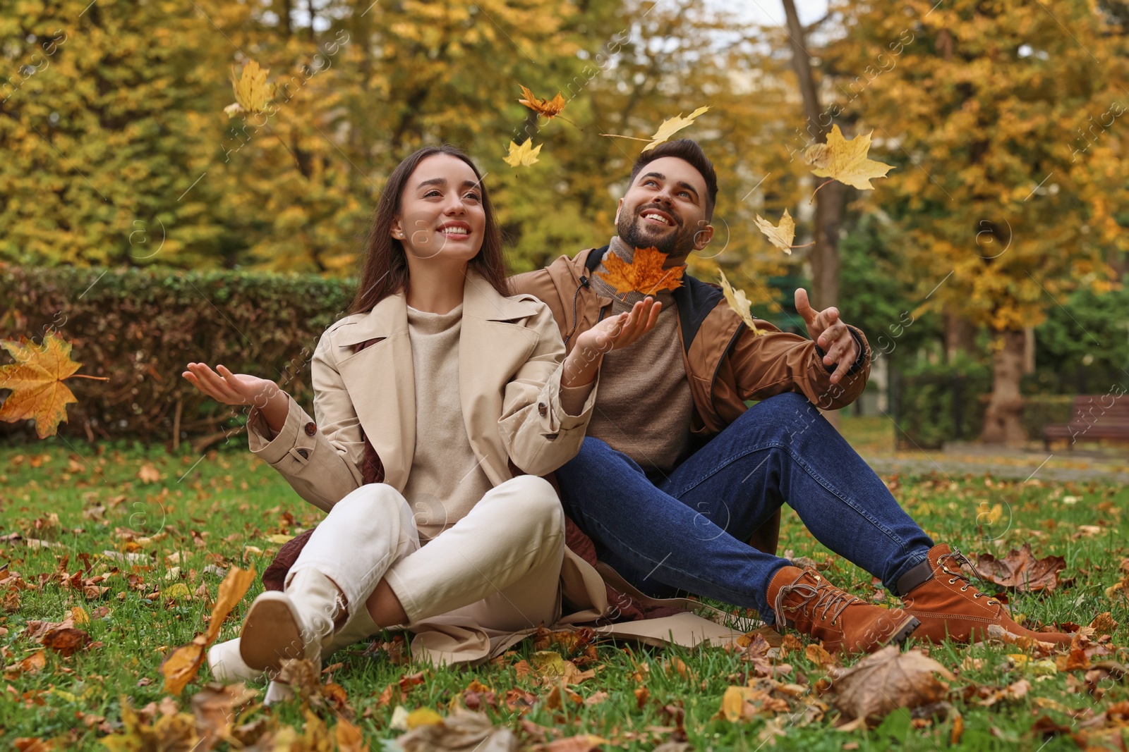 Photo of Happy young couple spending time together in autumn park