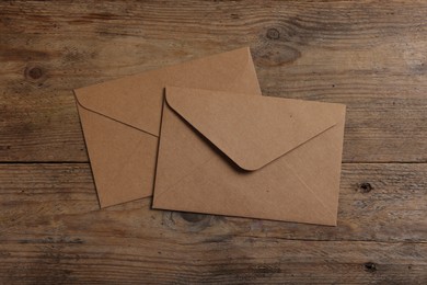 Paper envelopes on wooden table, flat lay