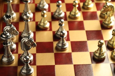 Wooden chessboard with different beautiful game pieces