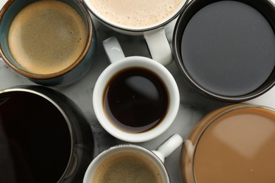 Photo of Different coffee drinks in cups on table, flat lay