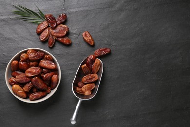 Photo of Flat lay composition with tasty sweet dried dates on black table. Space for text