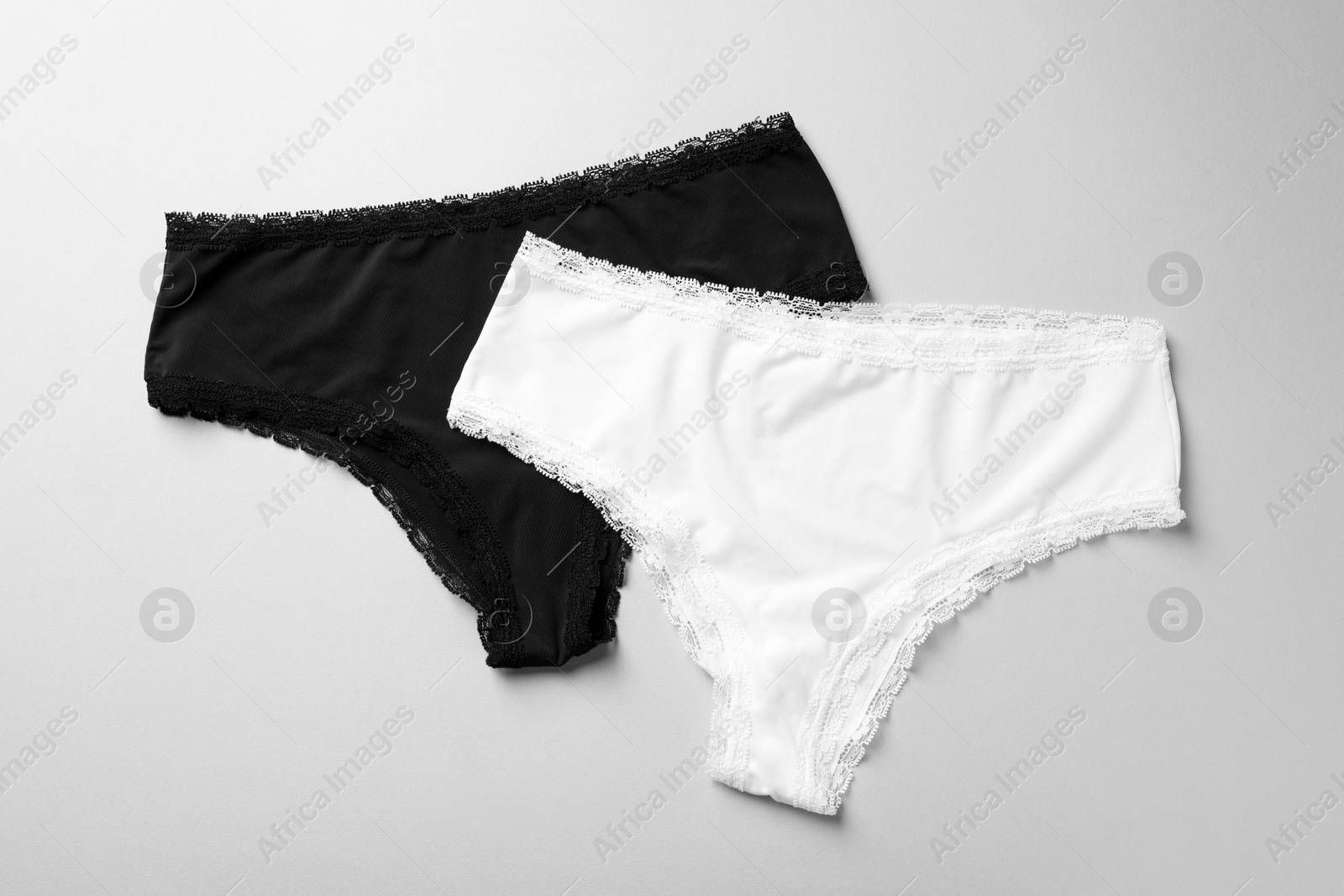 Photo of Women's underwear on light grey background, flat lay