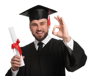 Happy student with graduation hat and diploma on white background