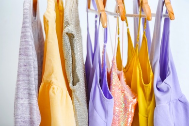 Photo of Different clothes on hangers, indoors