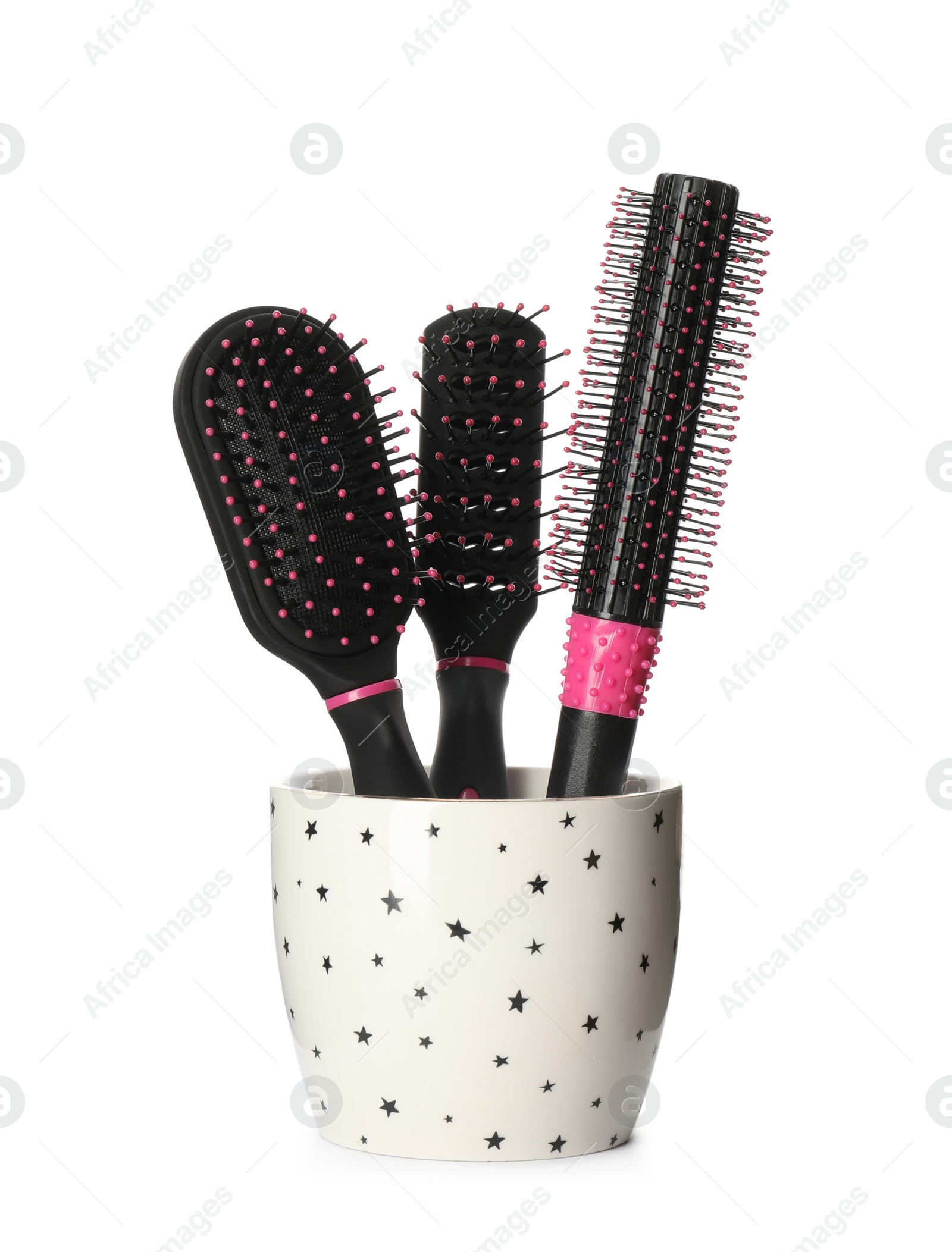 Photo of Set of hairbrushes in holder on white background