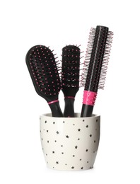 Photo of Set of hairbrushes in holder on white background