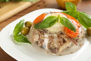 Delicious aspic with meat on wooden table, closeup