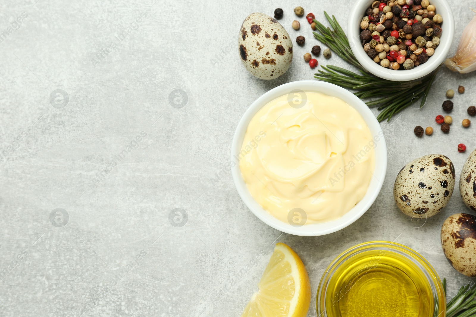 Photo of Delicious homemade mayonnaise, spices and ingredients on grey table, flat lay. Space for text