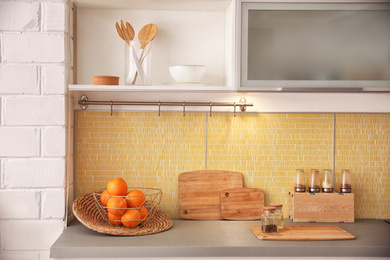 Photo of Fresh ripe oranges on countertop in kitchen