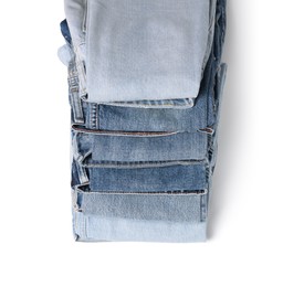 Image of Stack of different folded jeans isolated on white