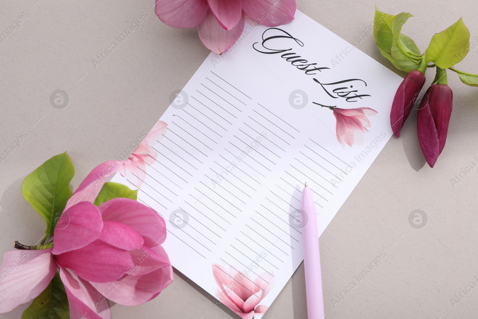 Photo of Guest list, pen and beautiful flowers on grey background, flat lay. Space for text