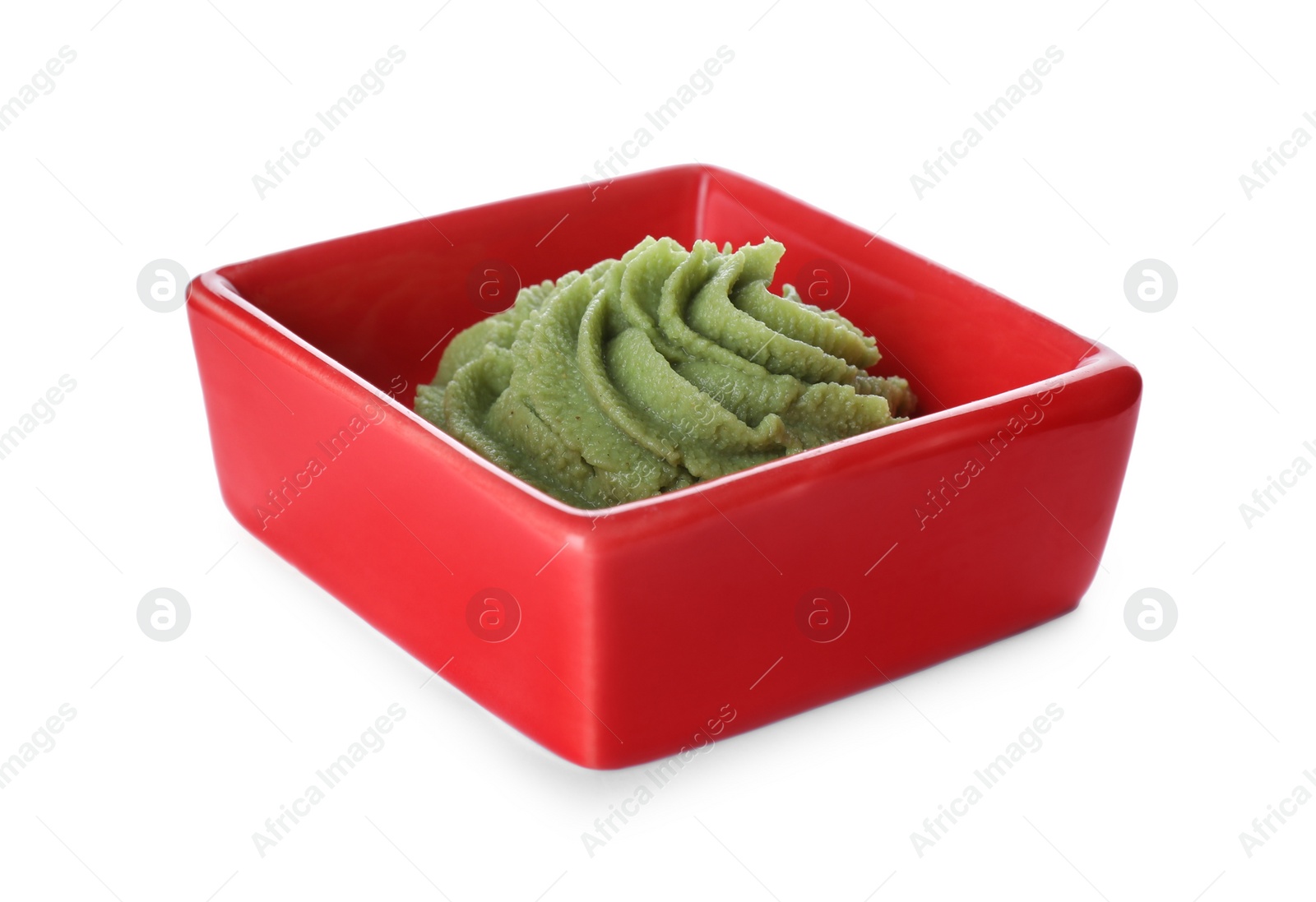 Photo of Bowl with swirl of wasabi paste isolated on white