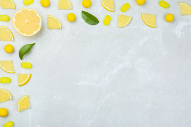 Photo of Flat lay composition with lemon drops on grey marble table. Space for text