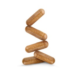 Vitamin. Many capsules falling on white background