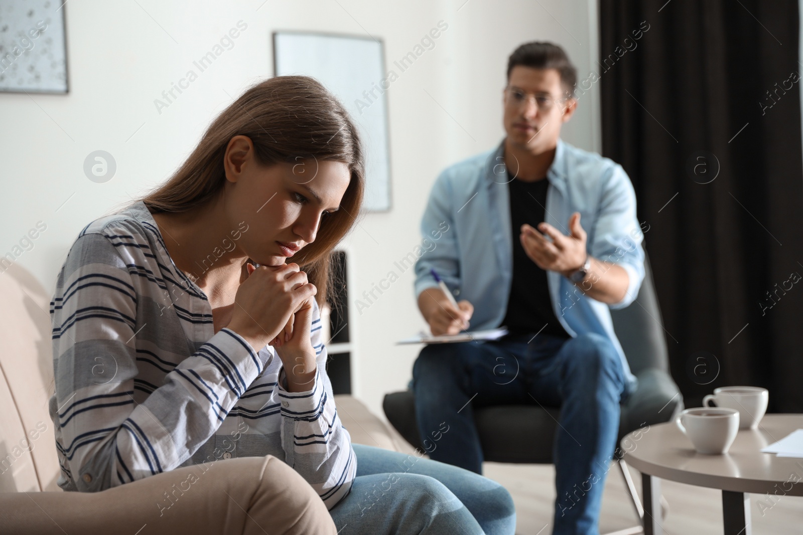 Photo of Professional psychotherapist working with patient in office