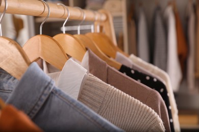 Wardrobe closet with different stylish clothes indoors, closeup