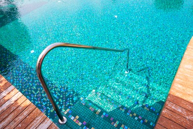 Photo of Outdoor swimming pool with steps and rail at resort