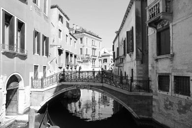 Image of VENICE, ITALY - JUNE 13, 2019: City canal with old buildings and boats. Black and white tone 