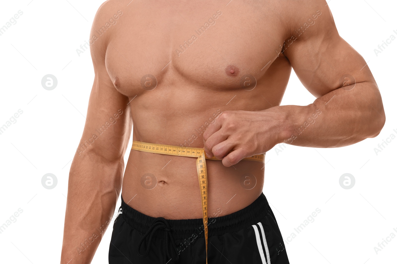 Photo of Athletic man measuring waist with tape on white background, closeup. Weight loss concept