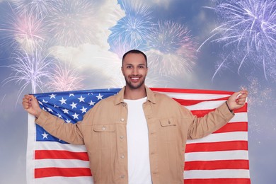 Image of 4th of July - Independence day of America. Happy man holding national flag of United States against sky with fireworks