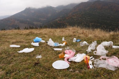 Plastic garbage scattered on grass in nature