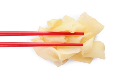 Photo of Chopsticks with pickled ginger on white background, top view