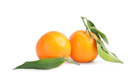 Tasty ripe tangerines with leaves on white background